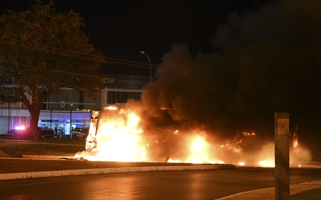 A bus burns following clashes between riot police and supporters of President Jair Bolsonaro protesting the arrest of an pro-right indigenous leader in Brasilia, on December 12.