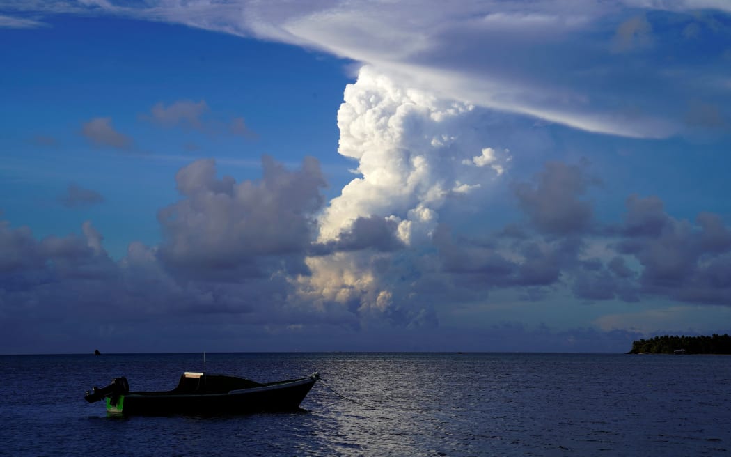 This picture taken on December 21, 2021 shows white gaseous clouds rising from the Hunga Ha'apai eruption seen from the Patangata coastline near Tongan capital Nuku'alofa.