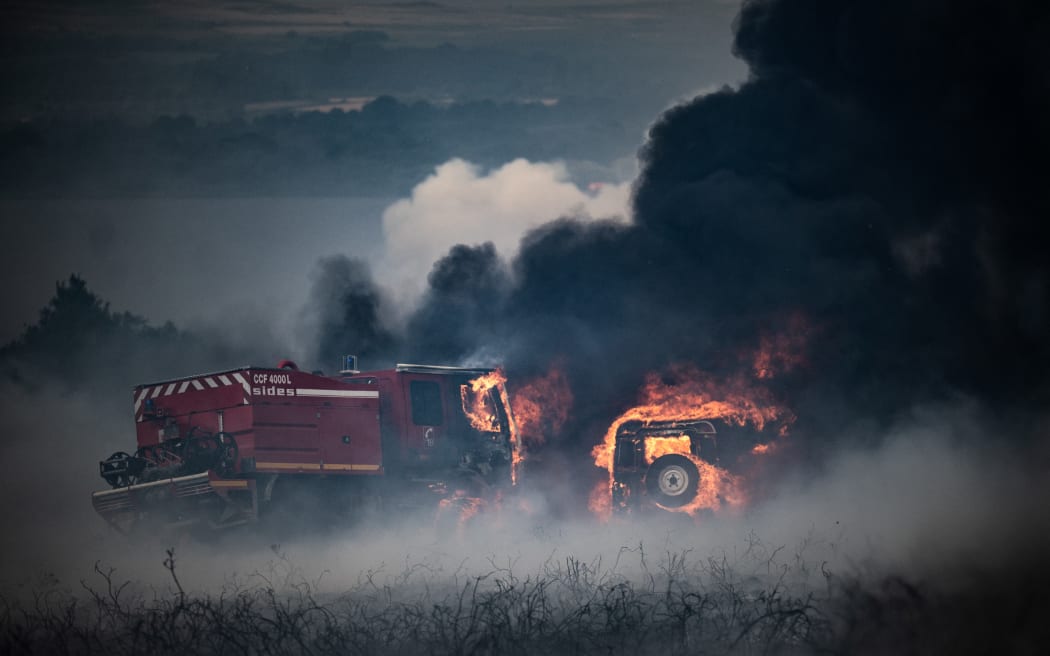 Fire trucks burn in a wildfire on the Mont d'Arrees, outside Brasparts, western France on 19 July 2022.