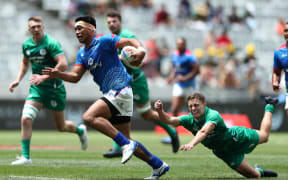 Samoa's Belgium Tuatagaloa breaks through the Ireland defence.