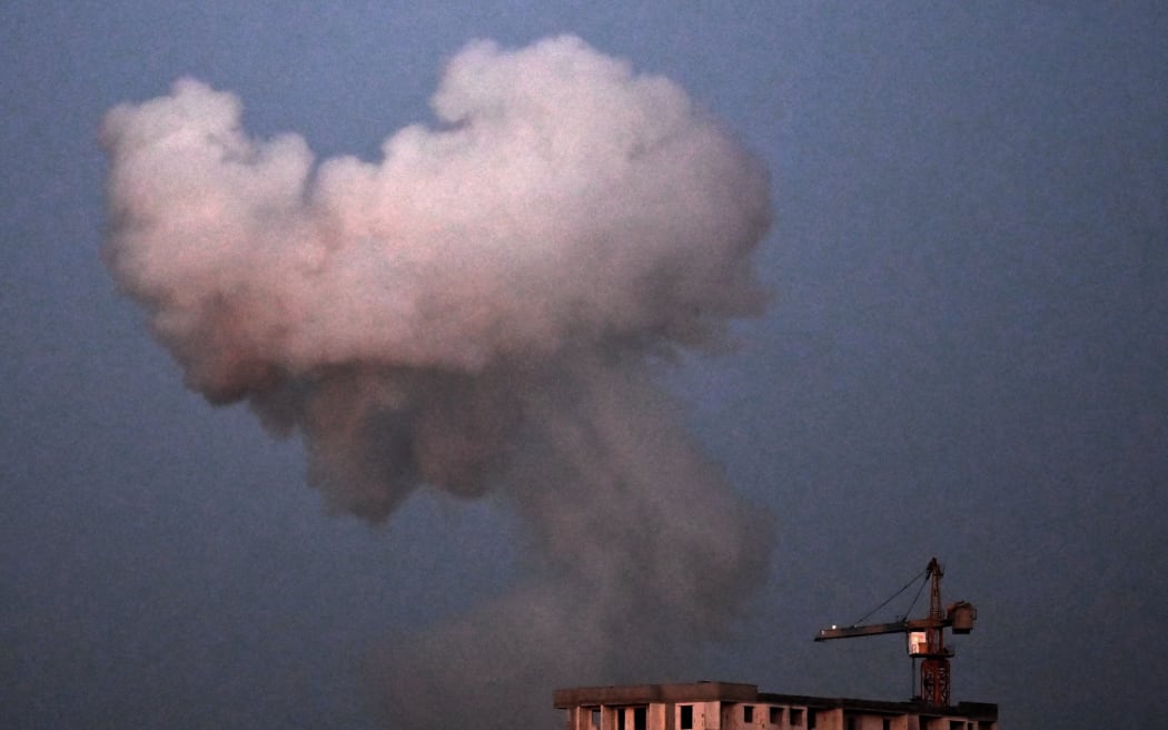 This picture shows smoke rising following an explosion during a night mass drone and missile strikes on Kyiv on August 28, 2025, amid the Russian invasion of Ukraine.