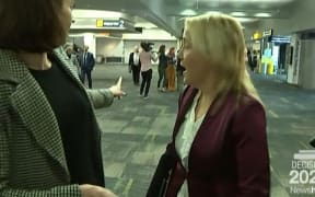 "She's behind you . . . " Tova O'Brien points to media pursuing inbound Judith Collins while pursuing inbound Nikki Kaye at the airport.