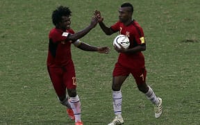 Raymond Gunemba celebrates one of his three goals against Samoa.