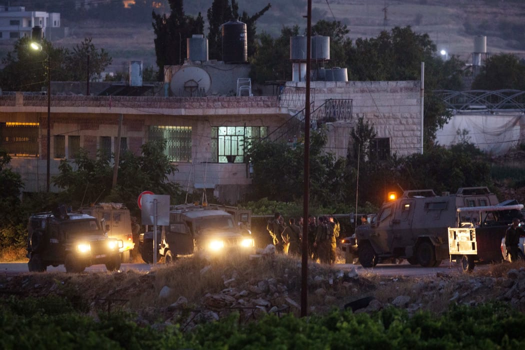 Israeli soldiers at the village of Halhul, near Hebron, where the bodies were found.