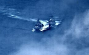 In this image provided by the U.S. Navy, a Russian destroyer, left, sails very close to the USS Chancellorsville, right, while operating in the Philippine Sea, Friday, June 7, 2019.