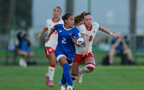 RABAT, MOROCCO - OCTOBER 22: Cali Willis of Samoa runs with the ball whilst under pressure from Olivia Chisholm of Canada during the FIFA U-17 Women's World Cup Morocco 2025 Group D match between Samoa and Canada at Football Academy Mohammed VI on October 22, 2025 in Rabat, Morocco. (Photo by Jonathan Moscrop - FIFA/FIFA via Getty Images)
