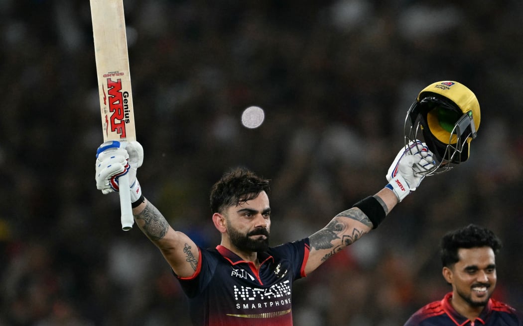 Indian cricketer Virat Kohli (L) of Royal Challengers Bengaluru celebrates after his team's victory against Gujarat Titans at the end of the 2026 Indian Premier League (IPL) T20 final at Ahmedabad's Narendra Modi Stadium on May 31, 2026. (Photo by Shammi MEHRA / AFP) / -- IMAGE RESTRICTED FOR EDITORIAL USE - STRICTLY NO COMMERCIAL USE --