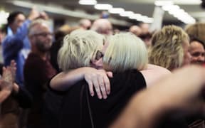 A passenger is reunited with loved ones after the first quarantine-free Wellington flight from Auckland disembarks.