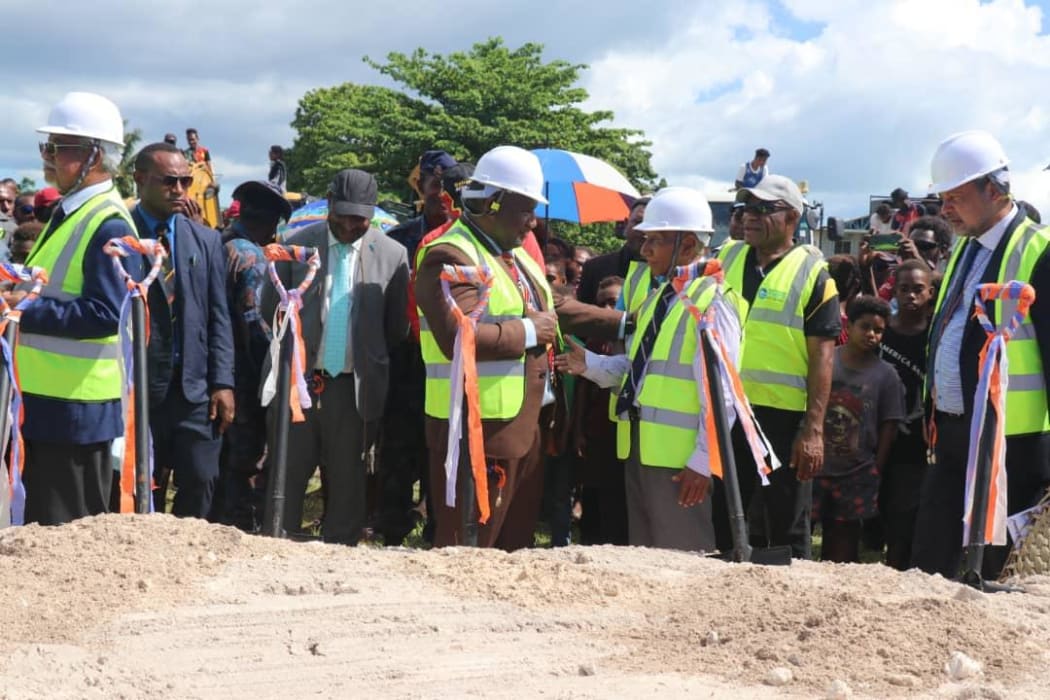 Papua New Guinea's Prime Minister James Marape (centre, brown suit) talks to New Ireland provincial Governor Sir Julius Chan at a groundbreaking ceremony for the upgrade of Kavieng airport, 16 July 2020.
