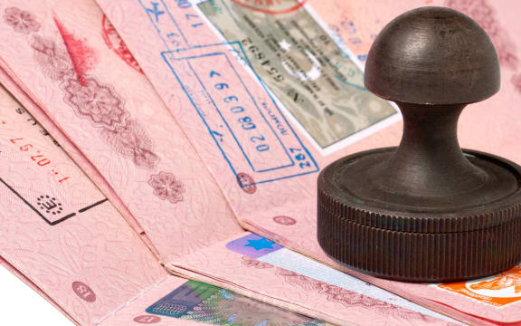 17128221 - a stack of passports and stamp isolated on white