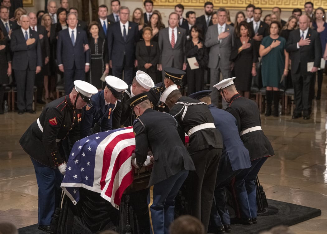 The casket containing the remains of former United States President George H.W. Bush arrives at the US Capitol. Monday, December 3, 2018.