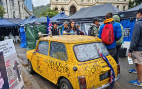 A graffiti covered car parked at the protest camp at Parliament.