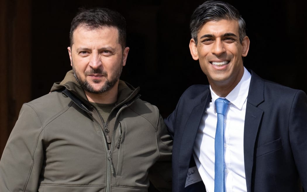 Britain's Prime Minister Rishi Sunak (R) greets Ukraine's President Volodymyr Zelensky at Chequers, the prime minister's official country residence, near Ellesborough, northwest of London, on May 15, 2023. Ukraine's President Volodymyr Zelensky arrived in Britain on Monday to meet Prime Minister Rishi Sunak, who pledged "hundreds" of both air-defence missiles and long-range attack drones to fend off Russia's invasion. (Photo by Carl Court / POOL / AFP)