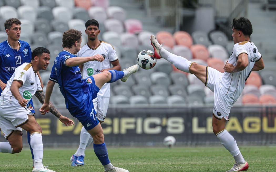 South Melboune FC's Max Mikkola and South Island United's Jaylen Rodwell tussle for the ball.
