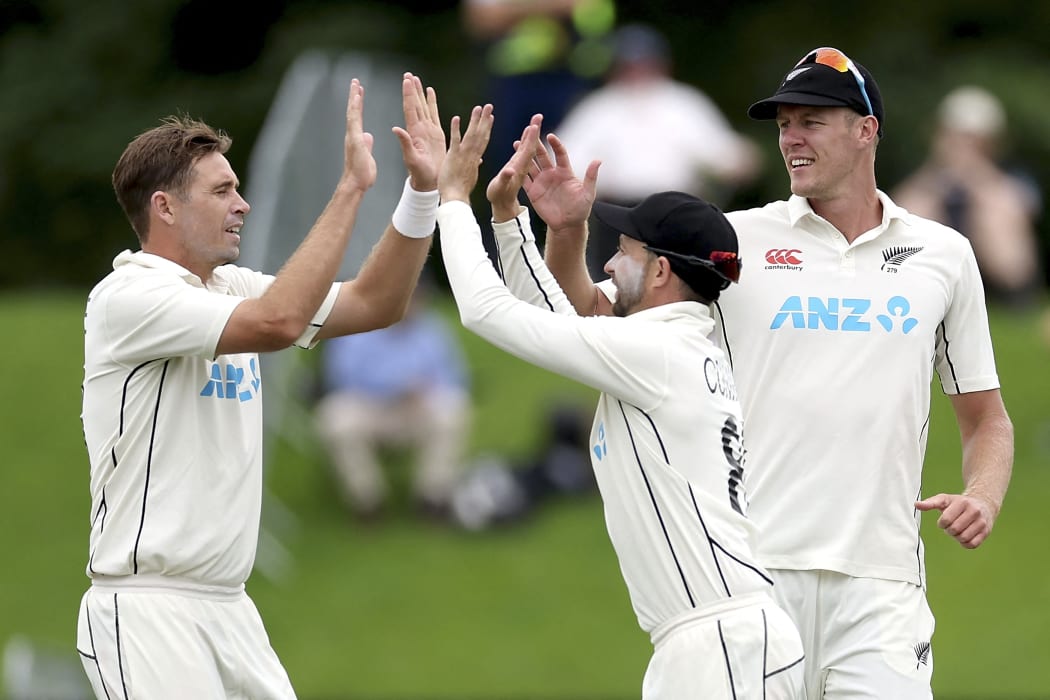 New Zealand's Tim Southee (L) celebrates the wicket of South Africa's Kyle Verreynne with teammates Devon Conway (C) and Kyle Jamieson during day three of the first cricket Test match with South Africa at Hagley Oval in Christchurch on February 19, 2022.