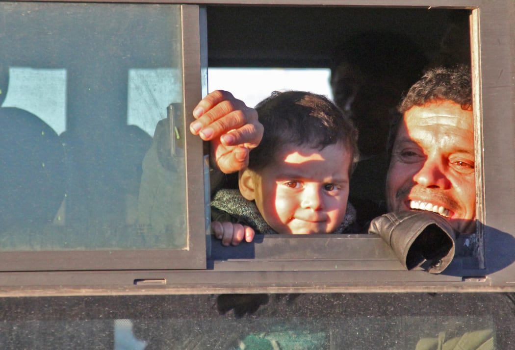 Syrians evacuated from rebel-held neighbourhoods in Aleppo  arrive in the opposition-controlled Khan al-Aassal region, west of the city, on 15 December. Civilians will be taken to  temporary camps on the outskirts of Idlib and the wounded to field hospitals.