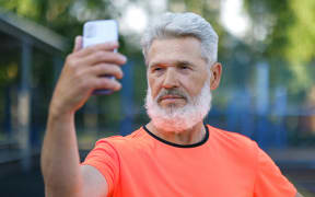 a middle aged man with mobile phone