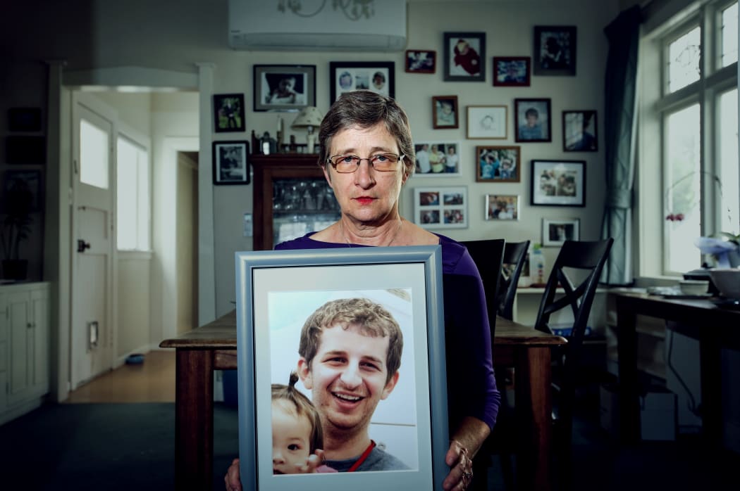Kelly Savage's mother, Martha Savage holds a picture of her son. Kelly Savage died in in Japan after being restrained in a bed of a psychiatric hospital for 10 days.