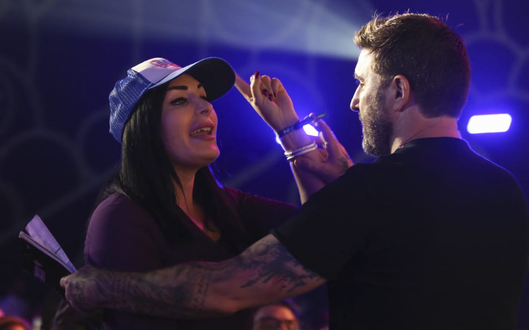 Republican activist Laura Loomer shouts at Jack Dorsey creator, co-founder, and Chairman of Twitter and co-founder & CEO of Square, as he speaks on stage during the crypto-currency conference Bitcoin 2021 Convention at the Mana Convention Center in Miami, Florida, on June 4, 2021. (Photo by Marco BELLO / AFP)