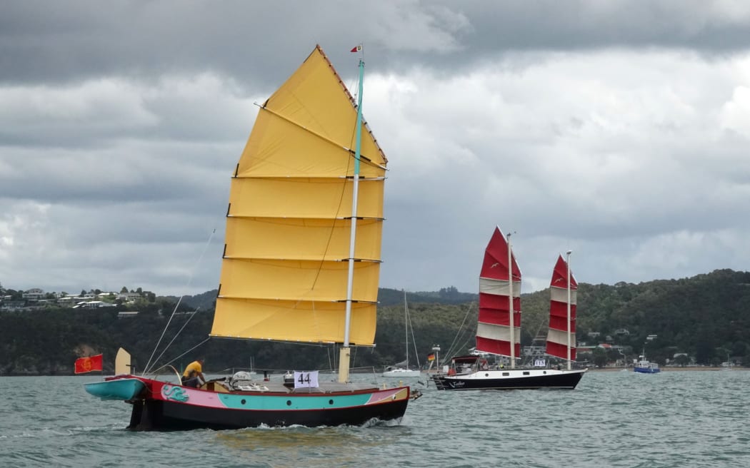 Junk rigs FanShi, left, and Taiko cross the finish line off Russell wharf.