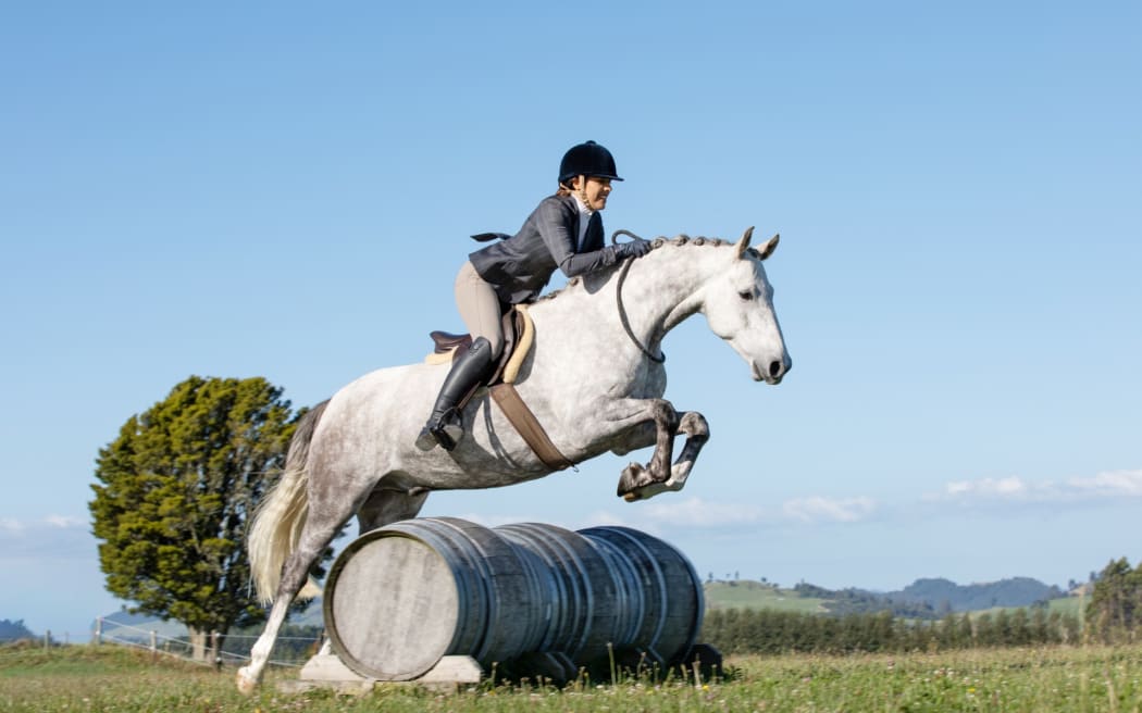 Kelly Wilson rides Patriotic, which was born to Kaimanawa horses, on her Taupō property.