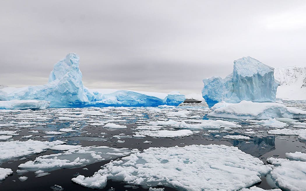 Ship dwarfed by the scale of Antarctic ice