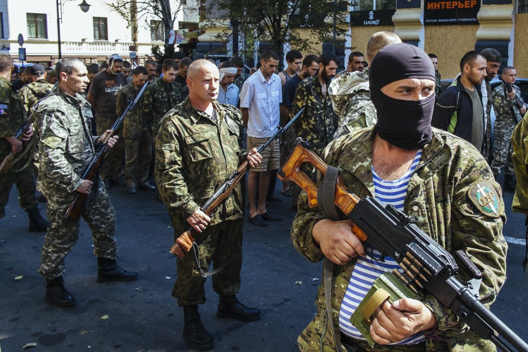Pro-Russian gunmen parade dozens of captured Ukrainian soldiers in Donetsk.