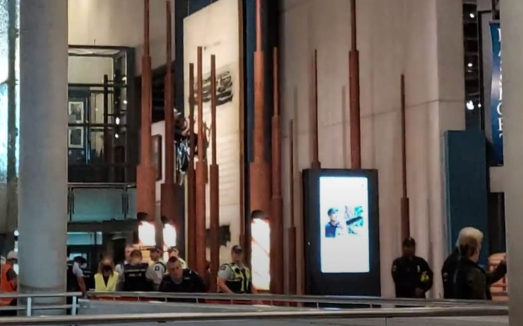 A panel which showed an English version of the Treaty of Waitangi at Te Papa museum has been damaged with spray paint on 11 December, 2023, as police surround the display.
