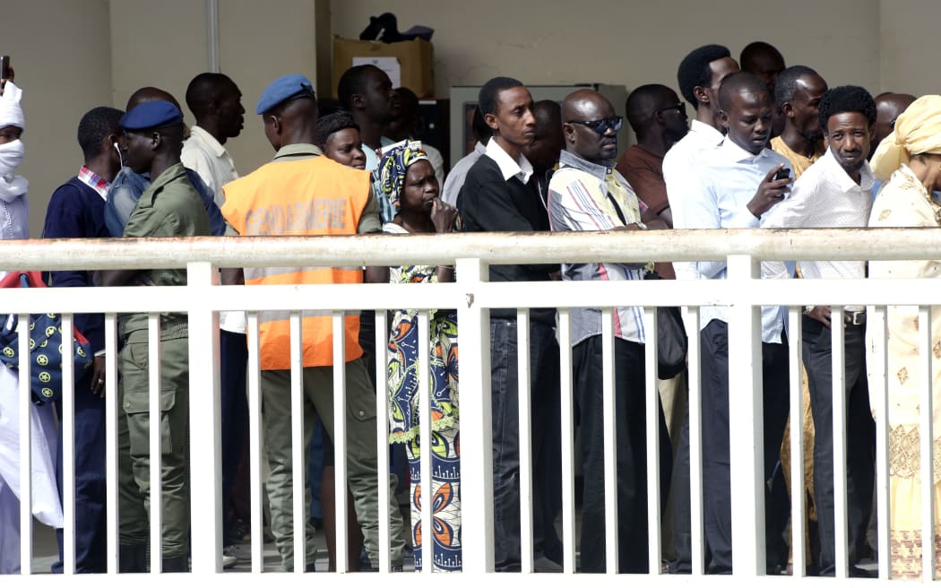 Members of the public wait at a security check point as they enter the Dakar courthouse to attend the sentencing of former Chadian dictator Hissene Habre on May 30, 2016
