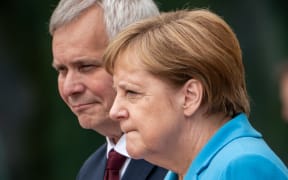 Chancellor Angela Merkel receives Finland's new Prime Minister Antti Rinne with military honours before the Federal Chancellery.