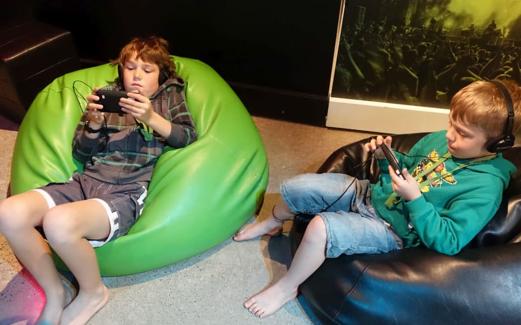 Riley Armstrong, 10, and his brother Floyd, 8, check out their compositions at the Musik: From Sound to Emotion exhibition in New Plymouth
