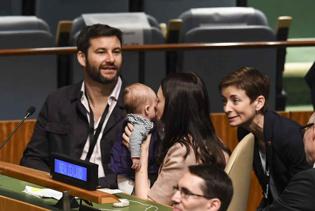 Jacinda Ardern kisses daughter Neve ans as her husband Clarke Gayford  looks on during the Nelson Mandela Peace Summit at the UN in New York.