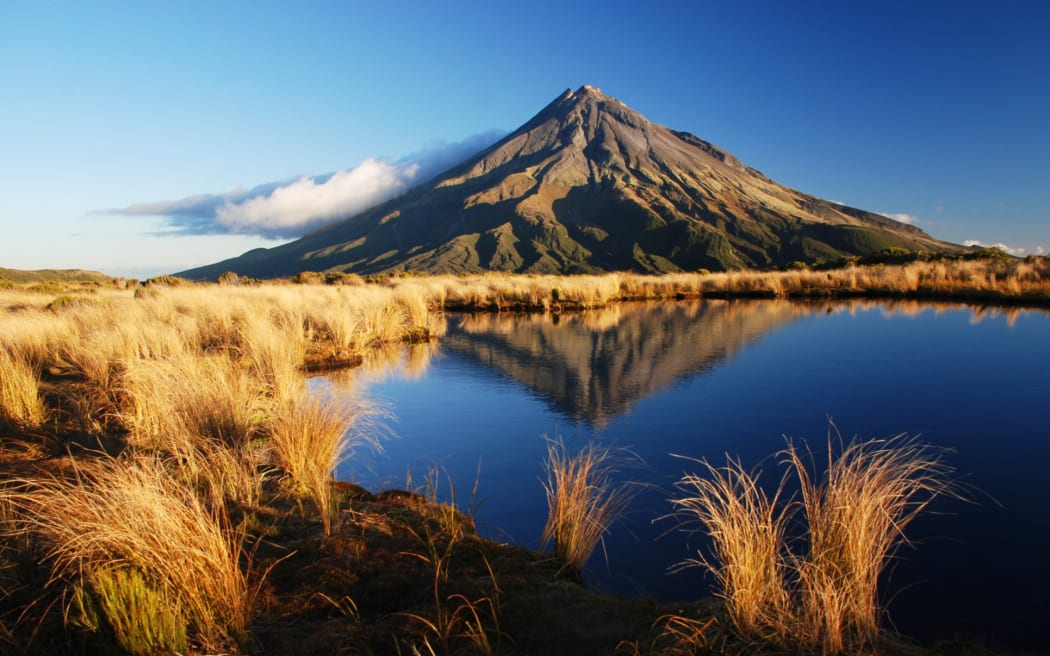 Mt Taranaki is reflected in the tarns on the Pouakai Crossing.