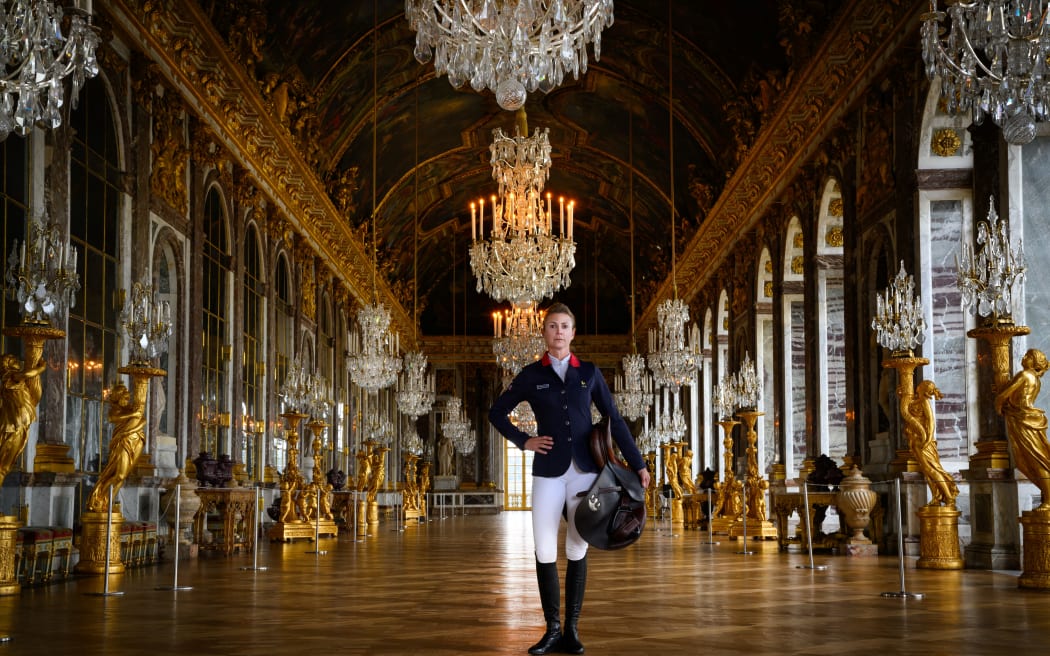 French show jumping rider and Olympic champion Penelope Leprevost poses in the Hall of Mirrors (Galerie des Glaces) in the Chateau de Versailles (Palace of Versailles), in Versailles, southwest of Paris on April 8, 2024, ahead of the Paris 2024 Olympic and Paralympic games. Become one of the most emblematic places of the Chateau de Versailles (Palace of Versailles), the Hall of Mirrors (Galerie des Glaces) was designed by Jules Hardouin-Mansart in 1678 and completed in 1684, replaces a vast terrace formerly opening onto the garden designed by Louis le Vau. (Photo by Stefano RELLANDINI / AFP) / RESTRICTED TO EDITORIAL USE