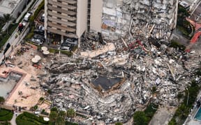 This aerial view, shows search and rescue personnel working on site after the partial collapse of the Champlain Towers South in Surfside, north of Miami Beach