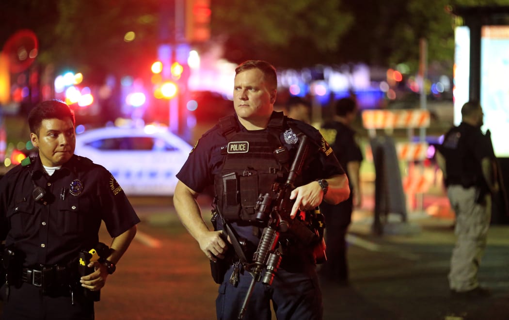 Dallas police stand watch near the scene where four Dallas police officers were shot and killed on July 7, 2016 in Dallas, Texas.