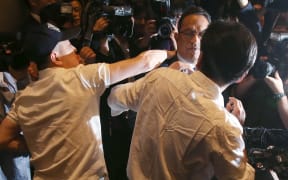 Atar Safdar (C), the head of Oxy Reckitt Benckiser Korea, is surrounded by the aggrieved relatives of victims.