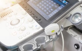 Medical ultrasound machine with linear probes in a hospital diagnostic room. Modern medical equipment, preventional medicine and healthcare concept.