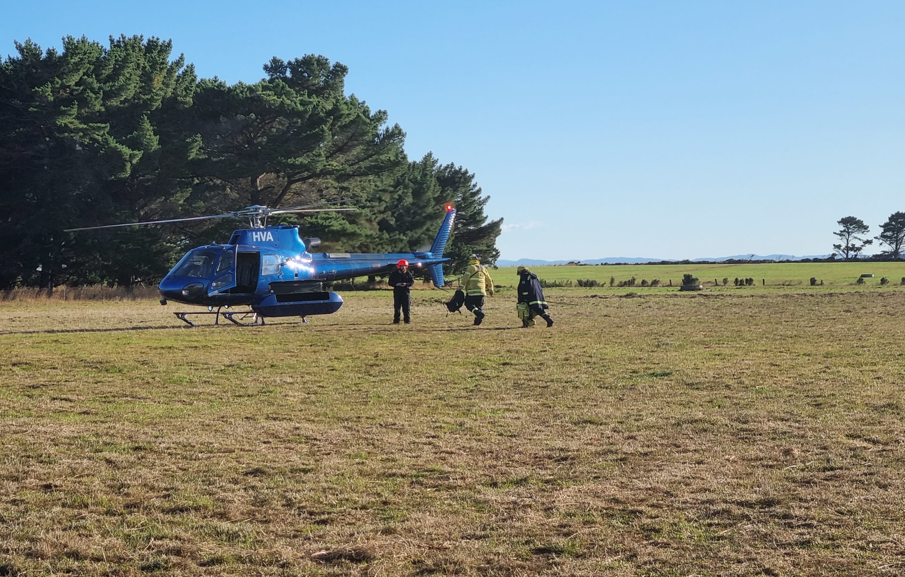 Firefighters have to be ferried out to the Awarua Bay fire by helicopter.