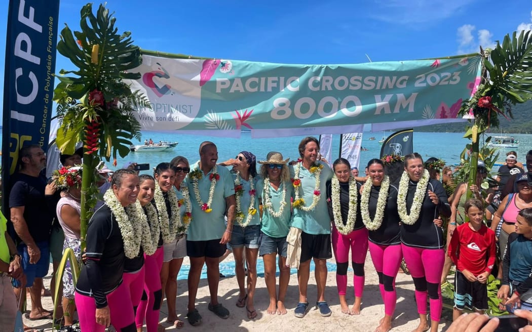 The women, on the left and right, are welcomed at Moorea.