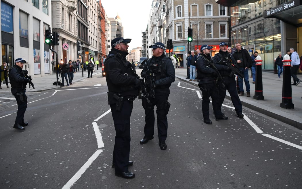 Armed policman stand guard at Cannon Street station in central London, on November 29, 2019 after reports of shots being fired on London Bridge.
