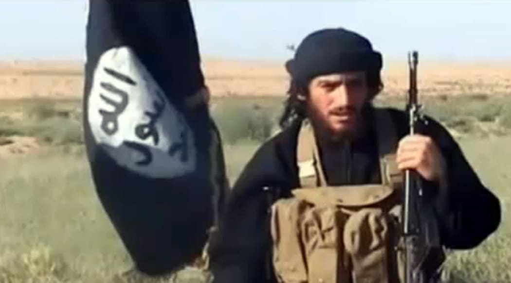 A screenshot from a video uploaded to YouTube in 2012 shows Abu Muhammad al-Adnani speaking next to an Islamic State flag at an undisclosed location.