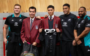 All Blacks Ollie Norris, Rieko Ioane and George Bower donate sports equipment during a community rugby session at Poneke Rugby Club.