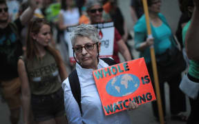 Demonstrators protest President Donald Trump's decision to exit the Paris climate change accord.