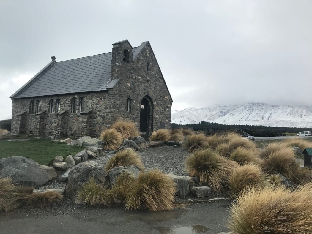 The Church of the Good Shepherd at Lake Tekapo with snow-capped mountains in the background in Wanaka.