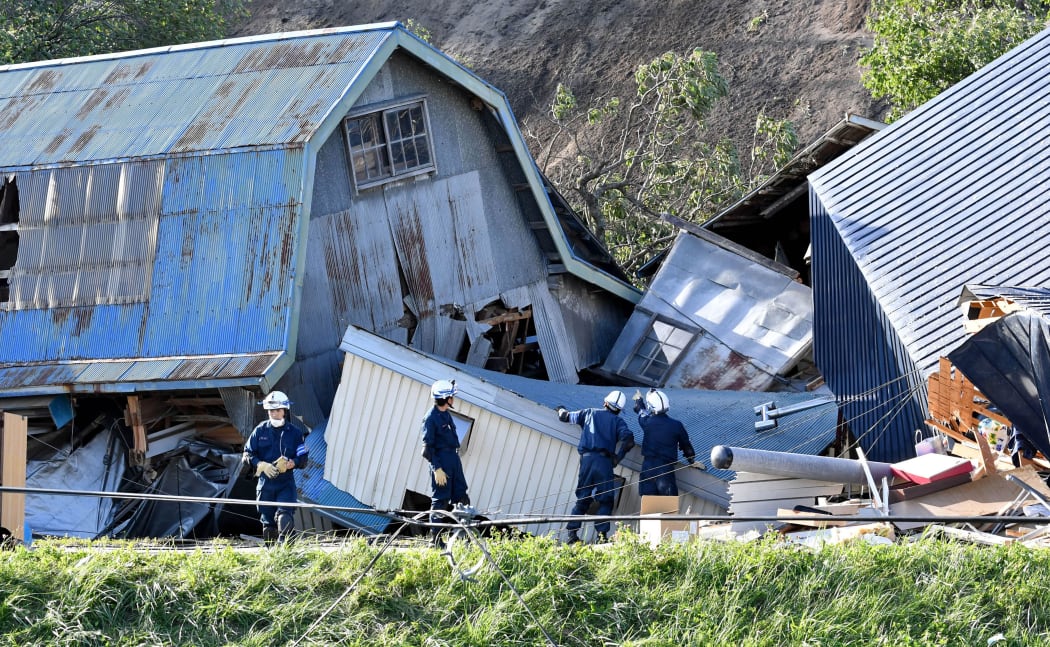 Police officers conduct a search at a collapsed house due to landslide in Atsuma Town, Hokkaido