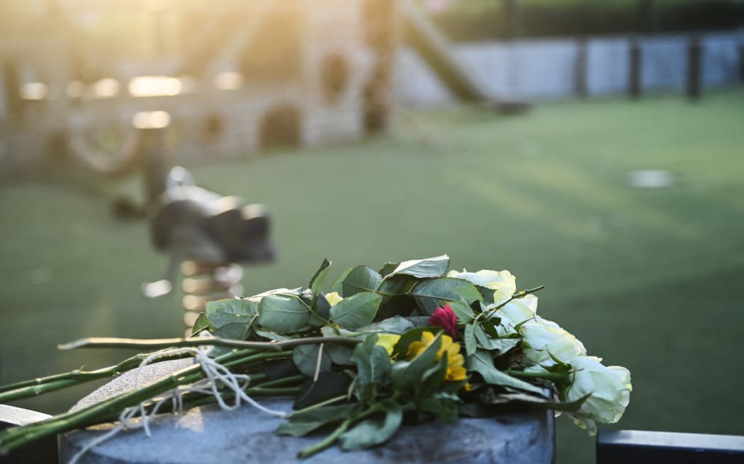 Flowers for the victims are placed at a playground in the 'Jardins de l'Europe' in Annecy, in the French Alps, on June 8, 2023, following a stabbing in the park.