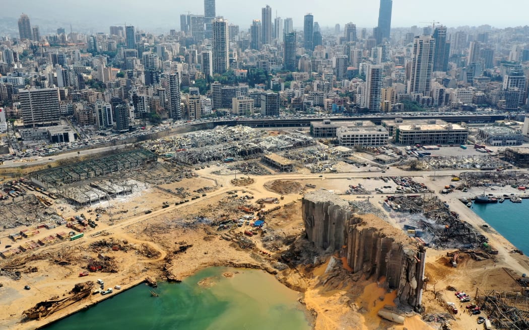 An aerial view taken on August 7, 2020, shows a partial view of the port of Beirut, the damaged grain silo and the crater caused by the colossal explosion three days earlier of a huge pile of ammonium nitrate that had languished for years in a port warehouse,