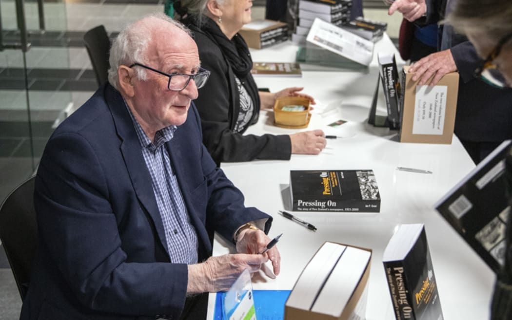 Ian F Grant signing copies of Pressing On at the National Library launch.