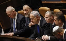 Israel’s Prime Minister Benjamin Netanyahu and members of his new cabinet look on during the government’s swearing in session at the Knesset in Jerusalem.